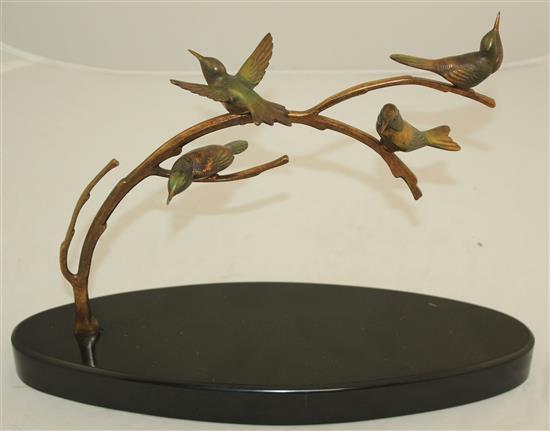 A 1920s French patinated bronze group of four birds upon a branch, L.14in.